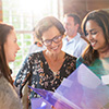 Women smiling looking at documents